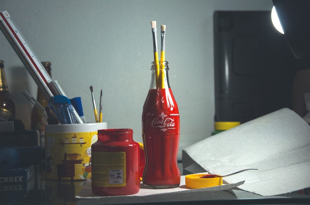 Coke bottle with paint brushes